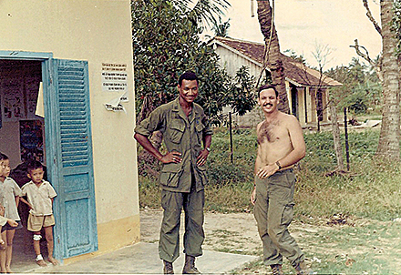 Dr. Elbert Nelson (left) with the battalion S-2 officer at a Medcap near Tay Ninh.